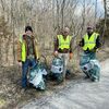 Jared Lami, Ethan Kleekamp, Brent McGuire help clean up the banks of Crane Creek.