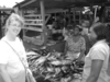 Tracey purchasing dried fish from the open market in Ghana.