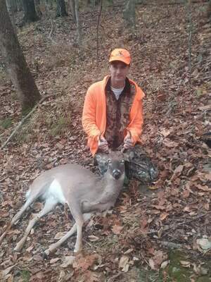 Kayden Looney, son of Mandy Looney, 14 years old, of Cape Fair, with his five point buck.